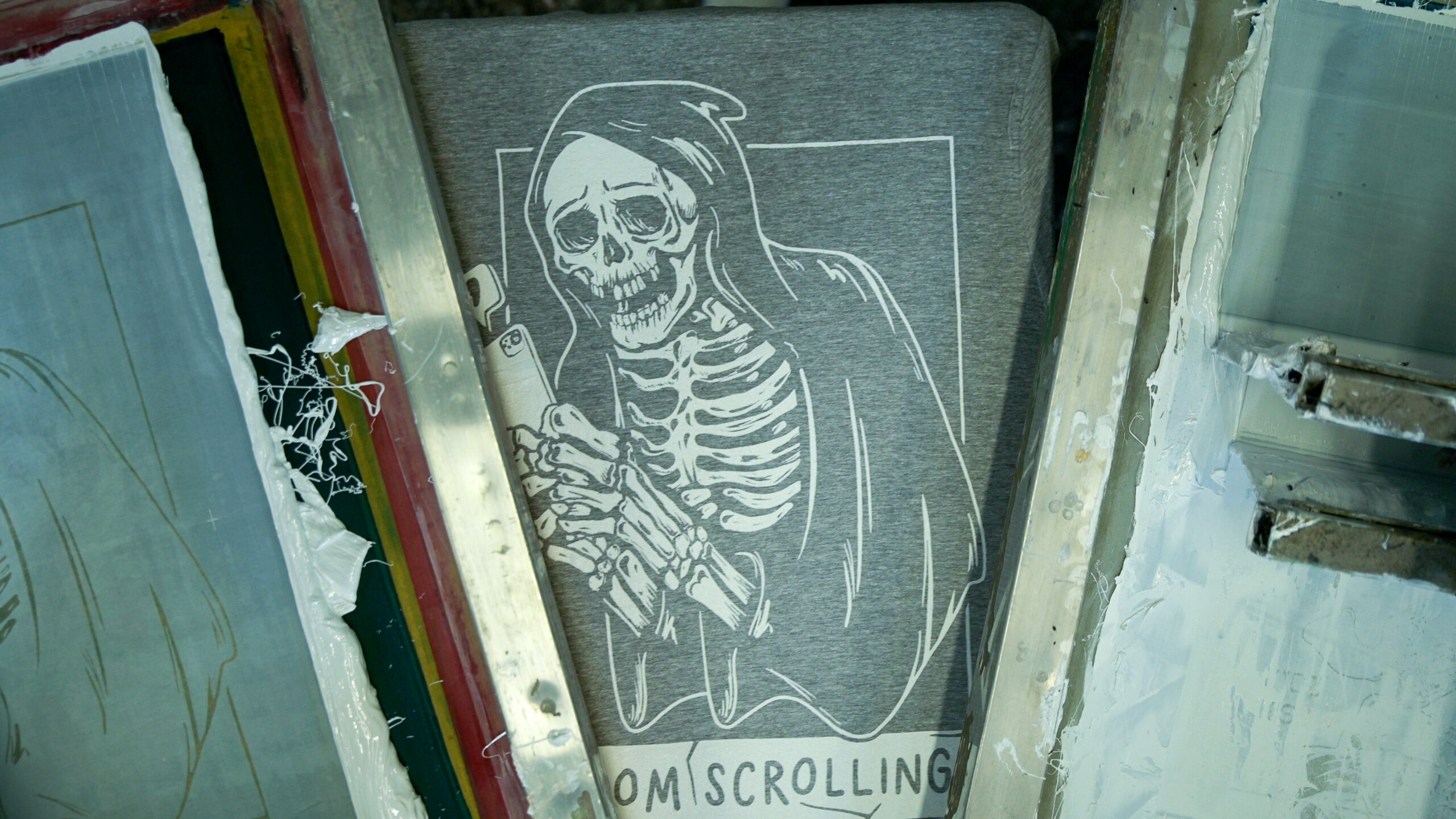 "merchandise design on a automated screen printing press"