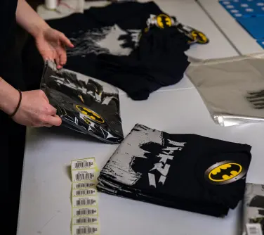 packing Batman t-shirts.