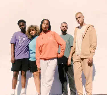 a group of people modelling stanley stella garments including blank hoodies and t-shirts.