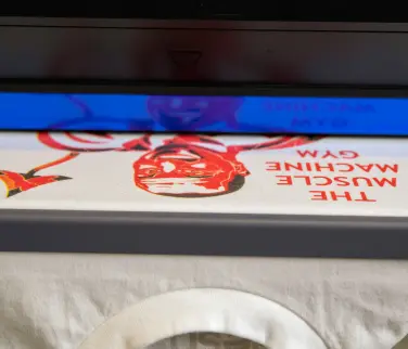 white t-shirt with a red direct to garment printing design in progress.