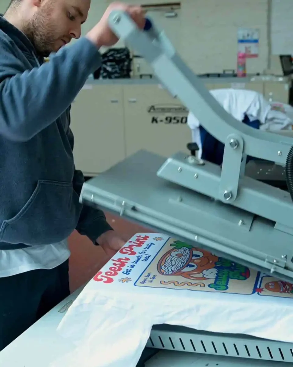 a person using an industrial heat press