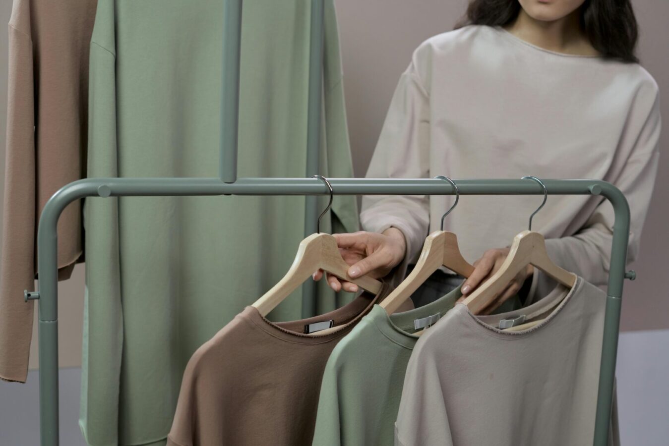 various blank garments hanging on a clothes rail