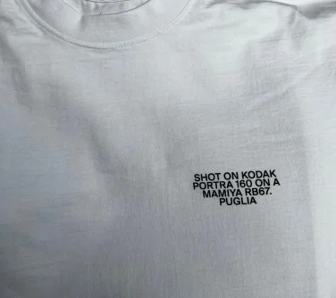 a branded heavyweight white t shirt with black text for uniform.