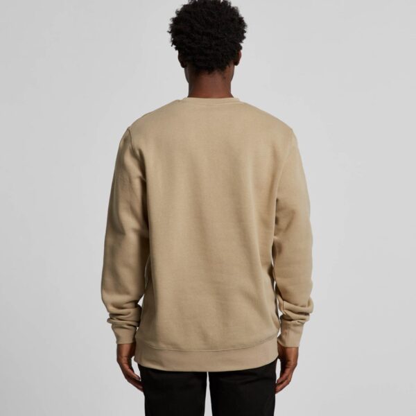 a model wearing a sand coloured sweatshirt facing away from the camera.