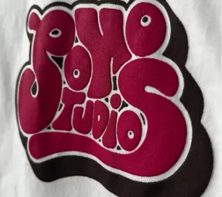 a puff print silkscreen printed quality t shirt with bubble writing print that reads "soho studios"