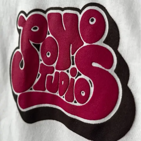 a puff print silkscreen printed quality t shirt with bubble writing print that reads 