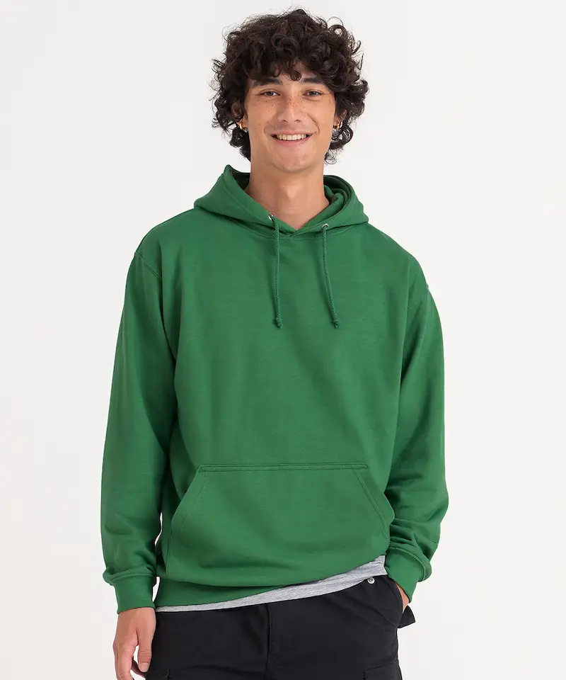 model with dark brown curly hair wearing a green awdis college hoodie