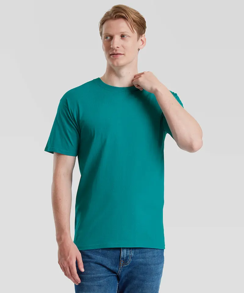 model with blonde hair wearing a teal fruit of the loom iconic tee and blue jeans